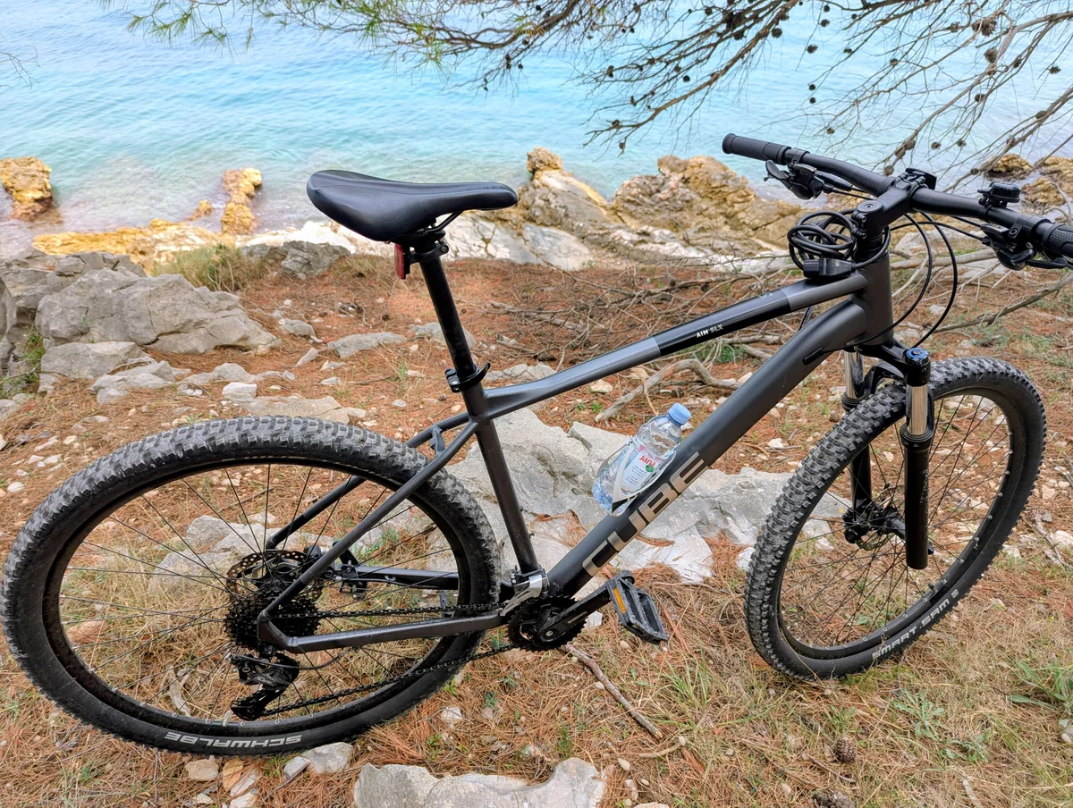 A mountain bike parked on rocks above the sea on Čiovo