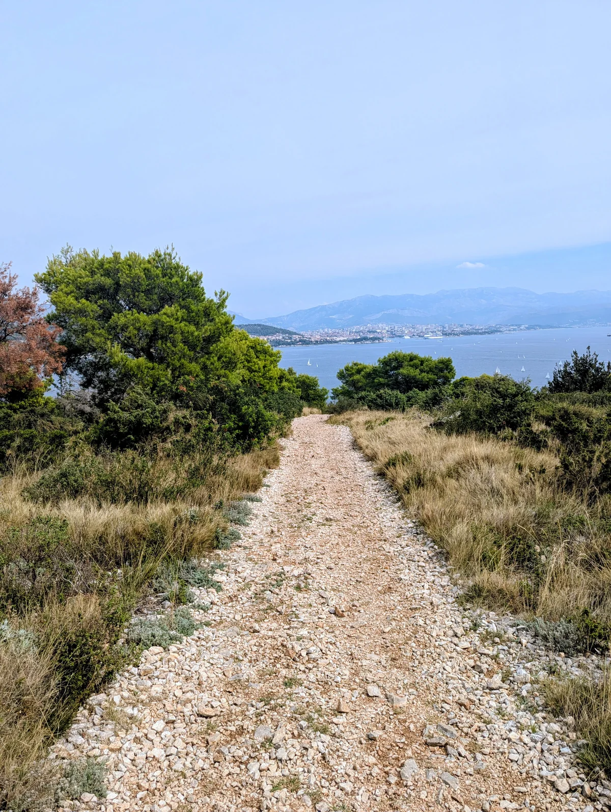 A rough stony gravel track through low scrub on Čiovo