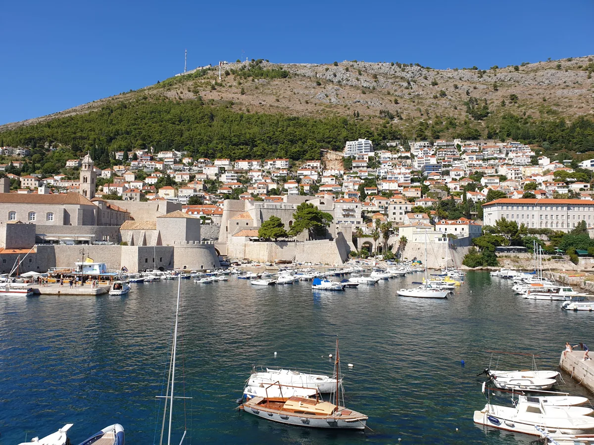 Dubrovnik's Old Port with small boats, below the city walls and fortresses