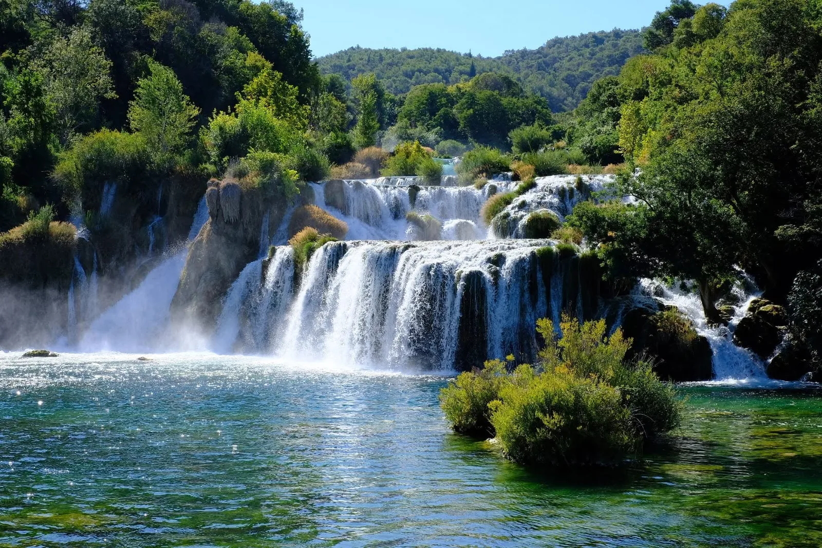 Skradinski buk waterfalls at Krka National Park, cascading into a turquoise pool between green banks