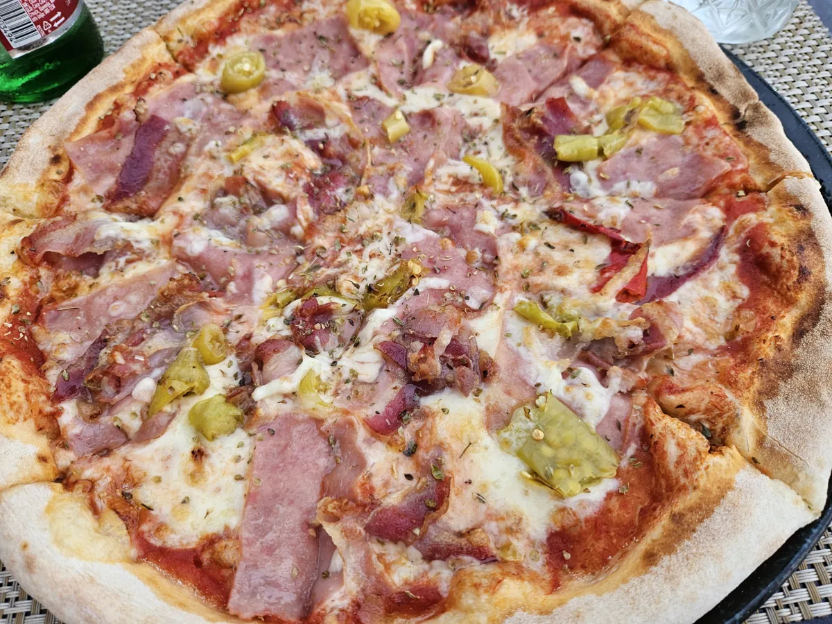 A thin-crust pizza topped with ham and mushrooms at Mirkec in Trogir