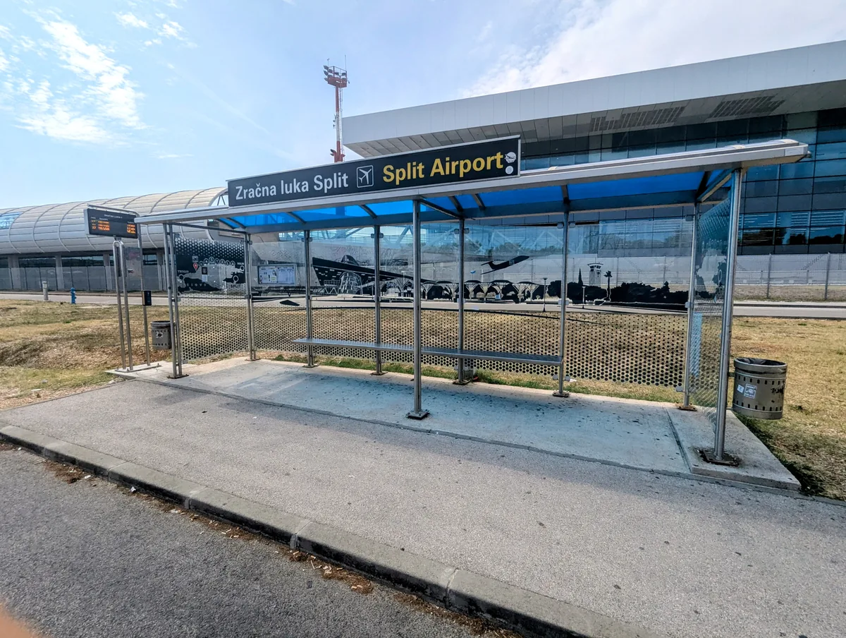 The bus shelter on the main road by Split Airport, with a sign reading Zračna luka Split — Split Airport