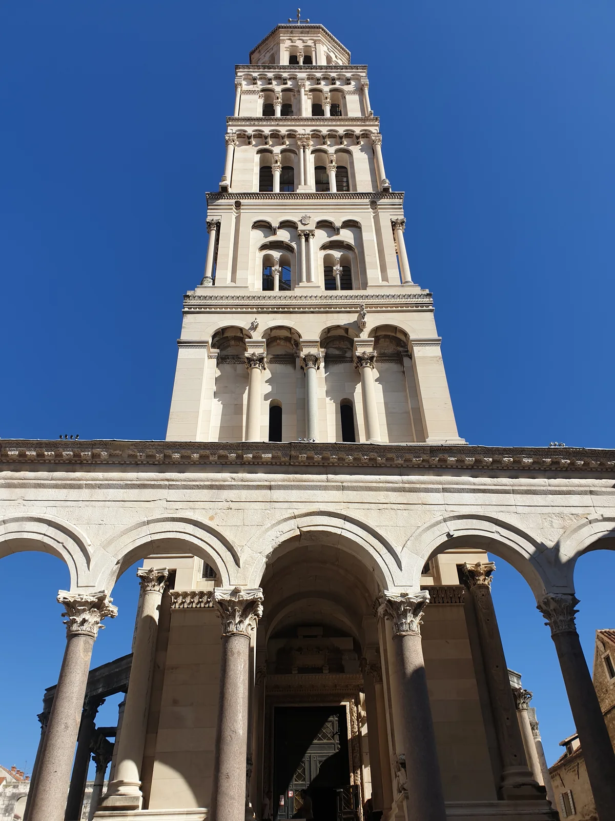 The Romanesque bell tower of the Cathedral of Saint Domnius seen from the Peristyle colonnade