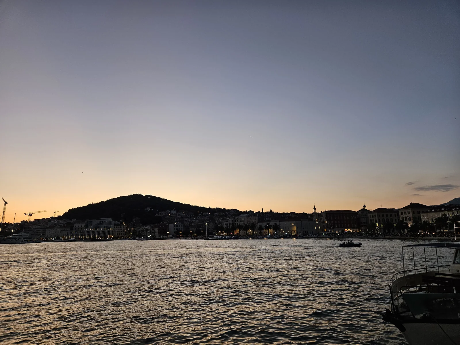 Split's harbour and Marjan hill at dusk, seen from the boat leaving for Trogir
