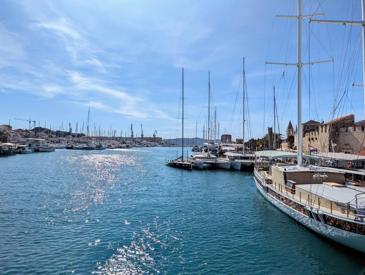 Sailing yachts moored in the channel between Trogir and Čiovo, seen from the old bridge