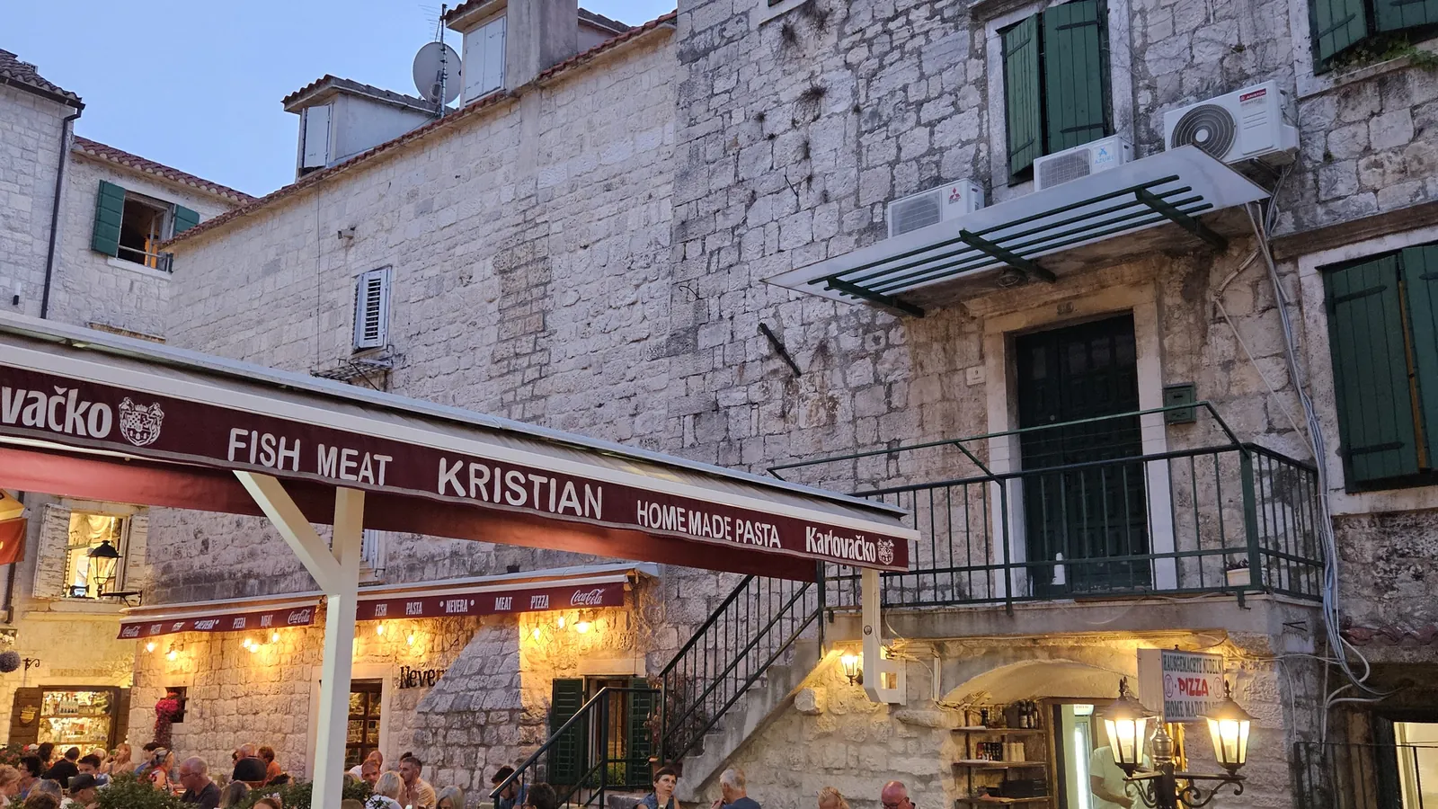 Restaurants and covered terraces along the edge of Trogir's old town