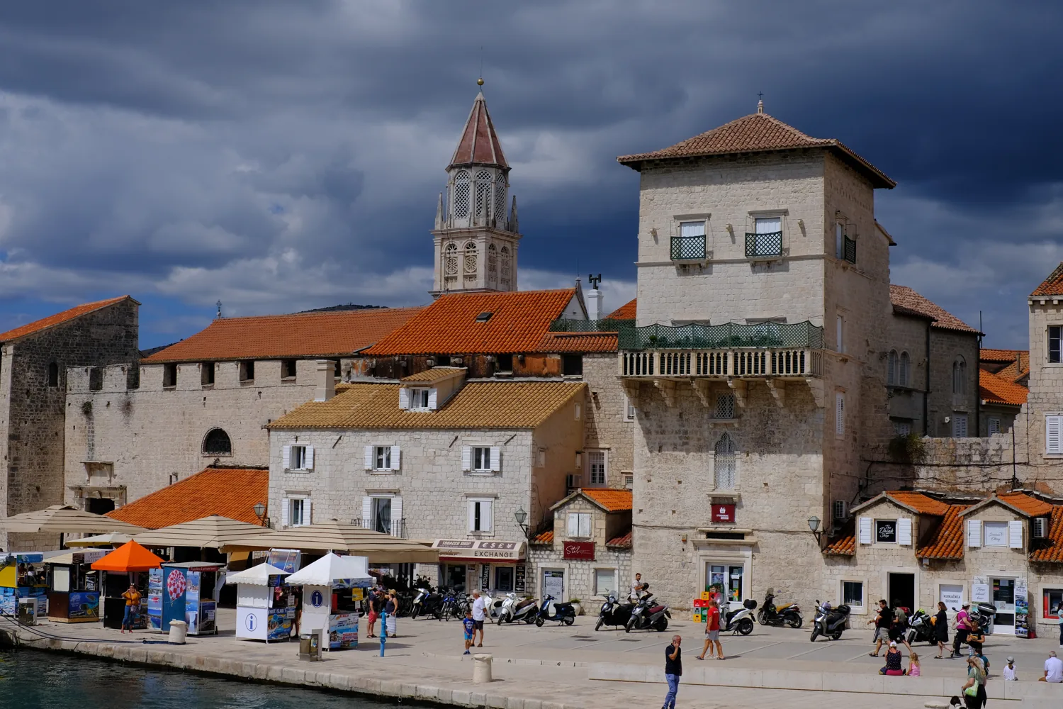 Trogir old town seen from the water, with the cathedral tower above the stone houses
